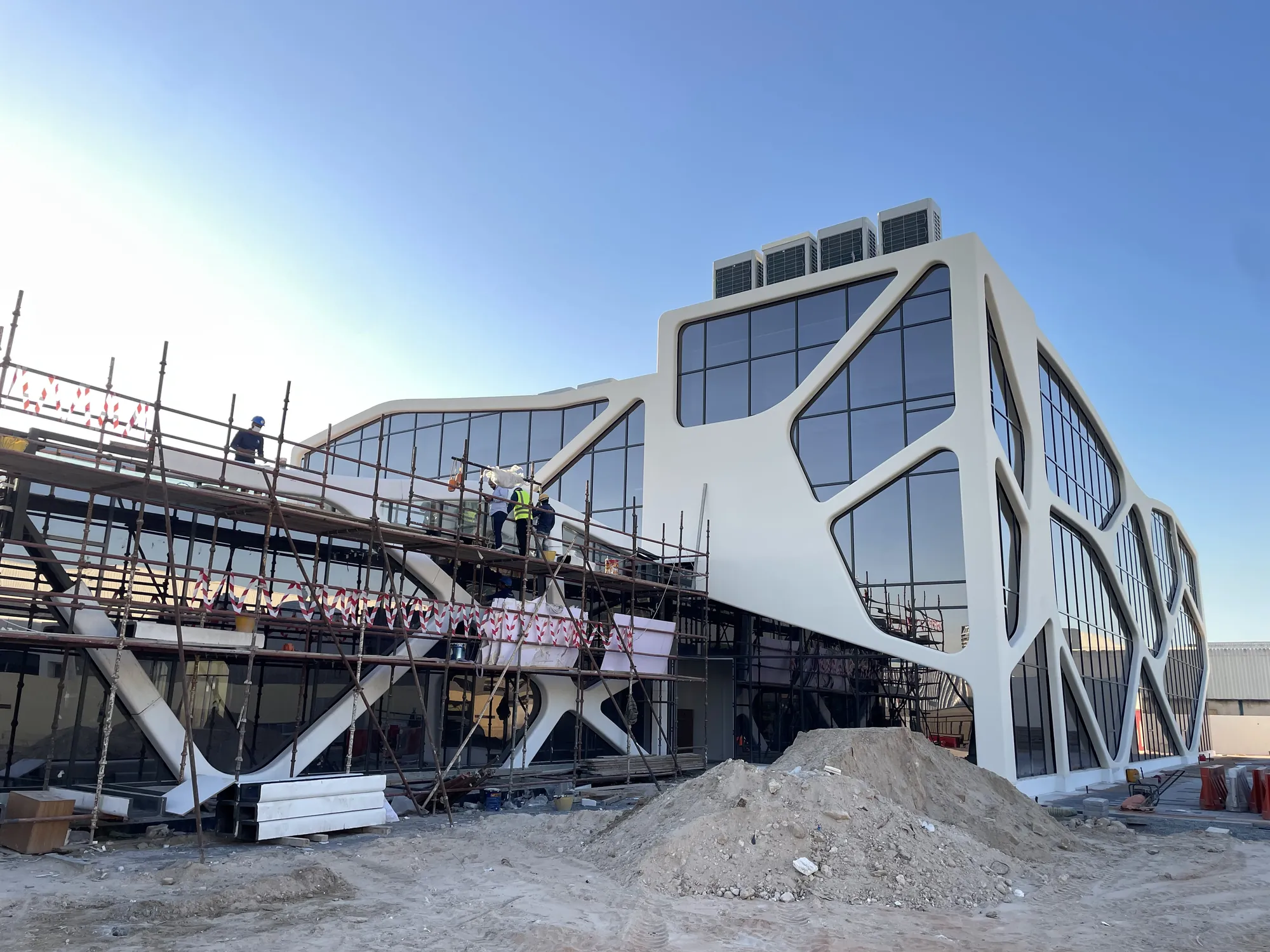 GFRC façade being installed on a sculpted building, UAE